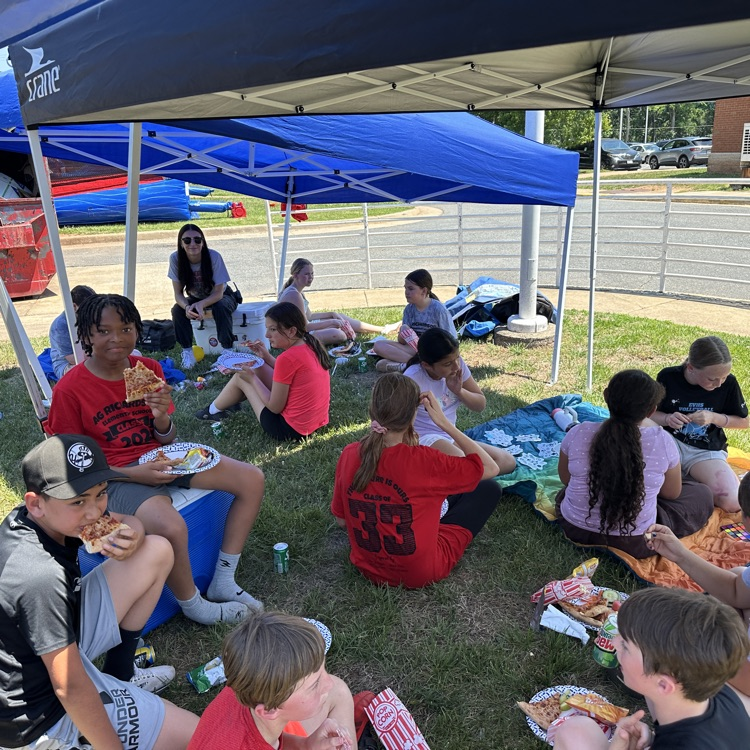 outside fifth grade party showing students enjoying fun and games and food