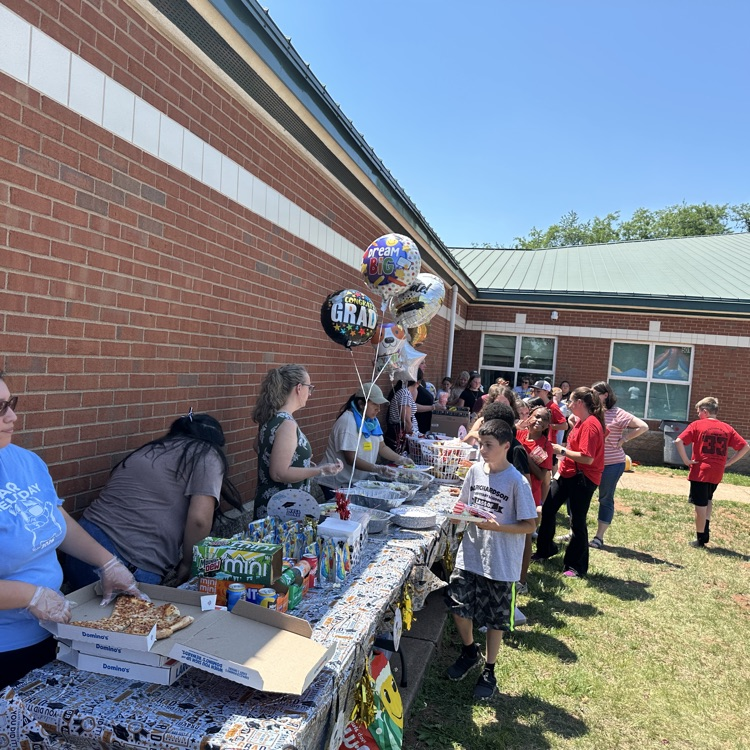 outside fifth grade party showing students enjoying fun and games and food