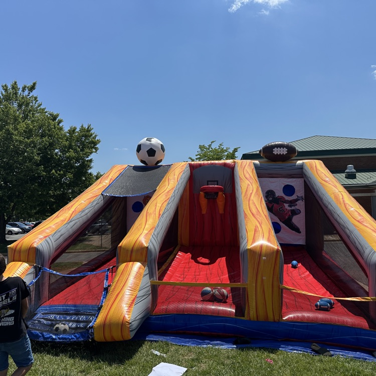 outside fifth grade party showing students enjoying fun and games and food