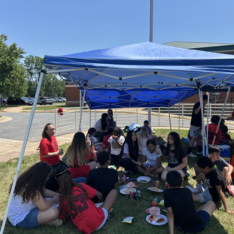 outside fifth grade party showing students enjoying fun and games and food