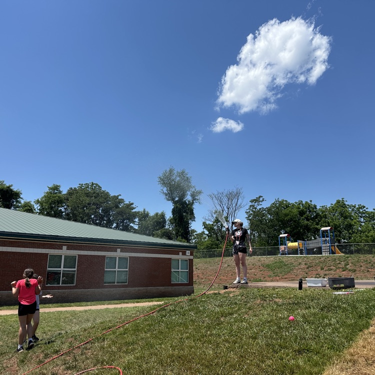 outside fifth grade party showing students enjoying fun and games and food