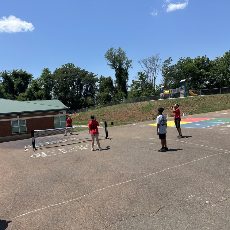 outside fifth grade party showing students enjoying fun and games and food
