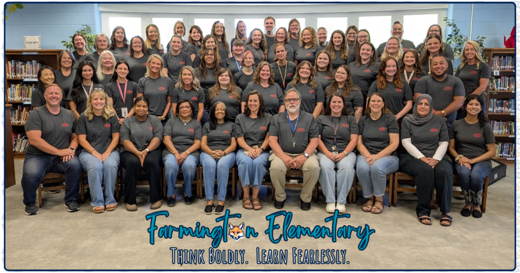 Staff photo taken in the library. All staff a wearing matching gray shirts. Text reads Farmington Elementary Think boldly. Learn Fearlessly. Front row is seated.