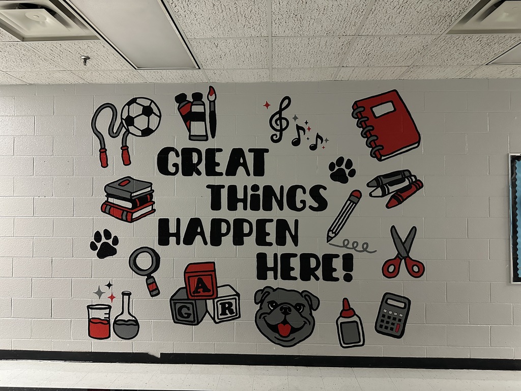 A picture of the final product with a mural saying great things happen here with school themed items accompanying the text