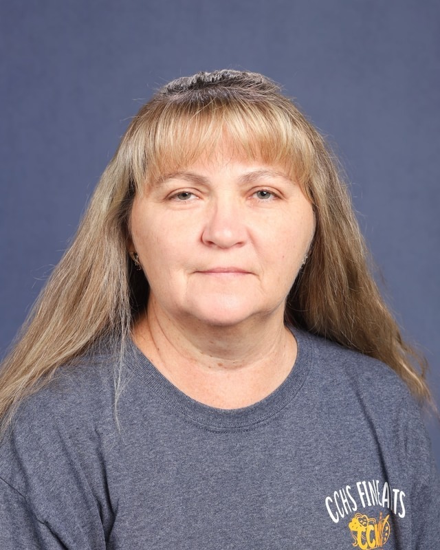 Woman with long, blonde hair wearing a gray t-shirt. The shirt reads "Class of 2021" in yellow text.