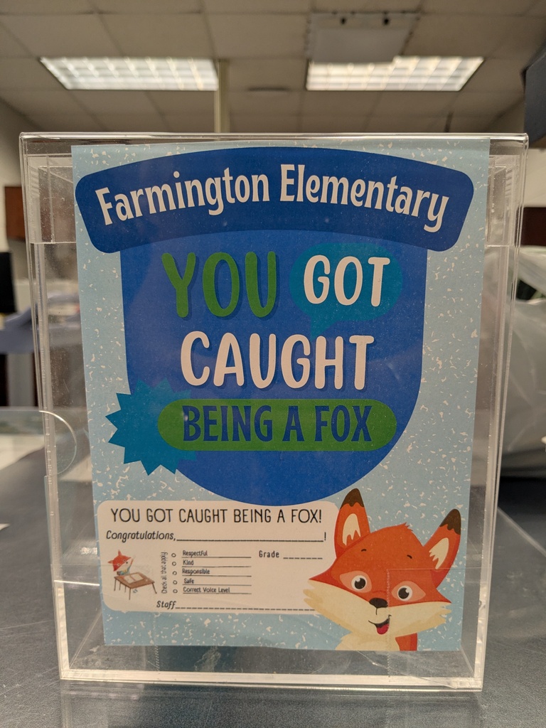 Display case with a sign reading "You Got Caught Being a Fox" from Farmington Elementary. The sign features a fox illustration.