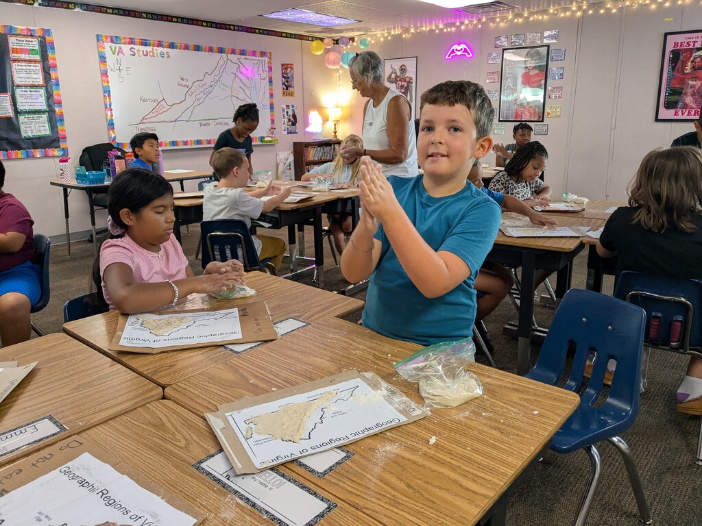 Elementary students shape dough on Virginia maps as they learn about the state’s geographic regions.
