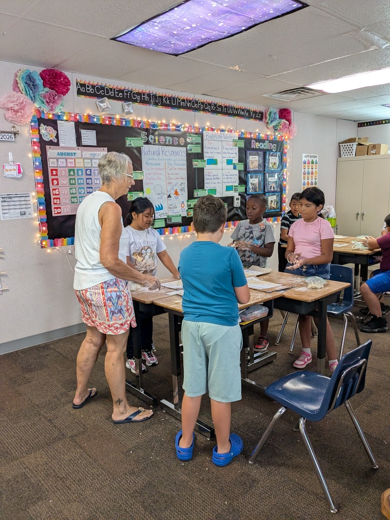 Students use dough to create maps of Virginia’s geographic regions during a hands-on classroom activity while teachers assist.