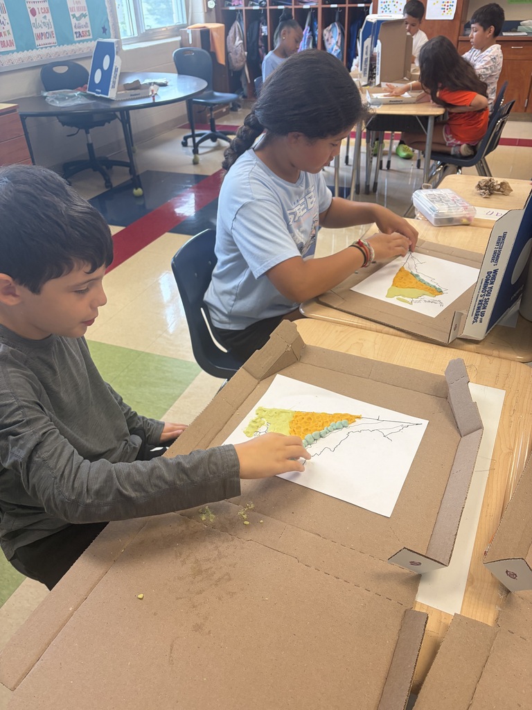 Students use colorful modeling clay to create three-dimensional maps of Virginia’s geographic regions on paper maps inside pizza boxes.