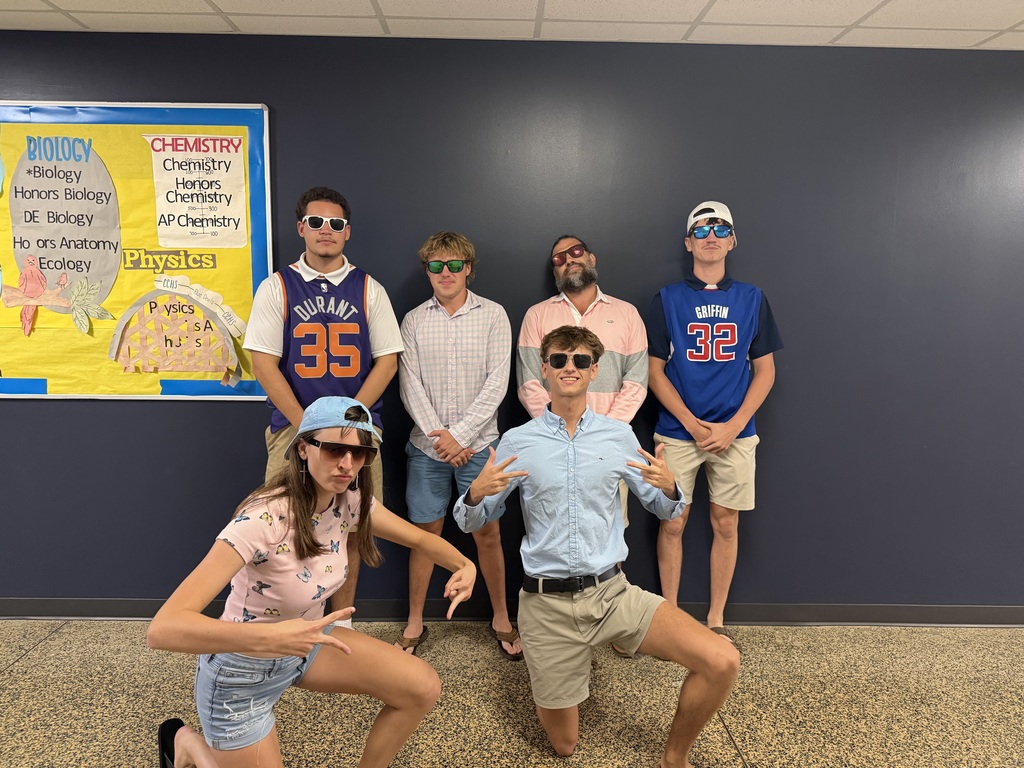 High schoolers in front of a navy wall