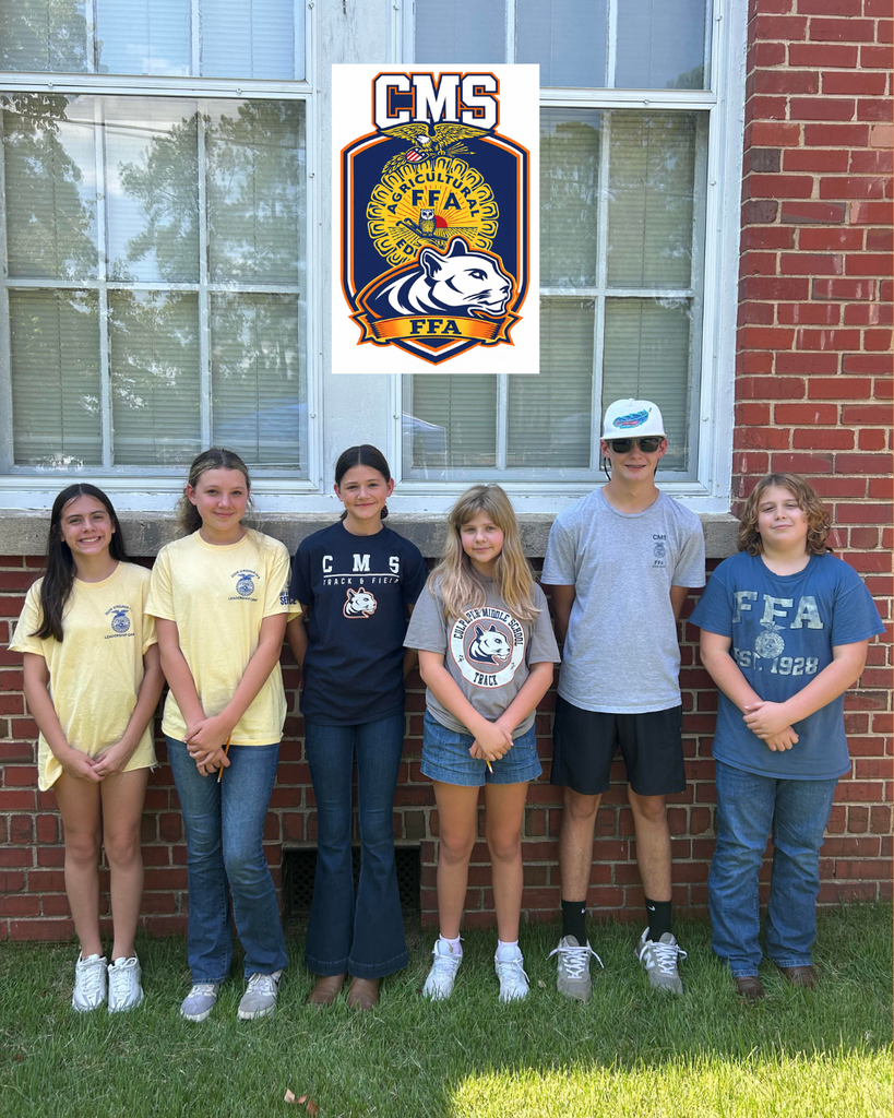 Six CMS FFA officers stand together outside the school beneath a CMS FFA Cougar logo. The students are dressed casually, with several wearing FFA or CMS shirts.