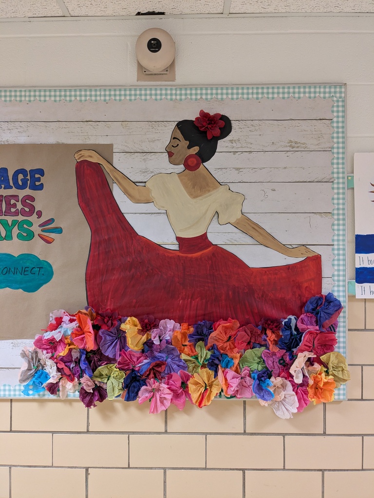 Painting of a woman in a red dress with a flower in her hair. Below, a row of colorful paper flowers.