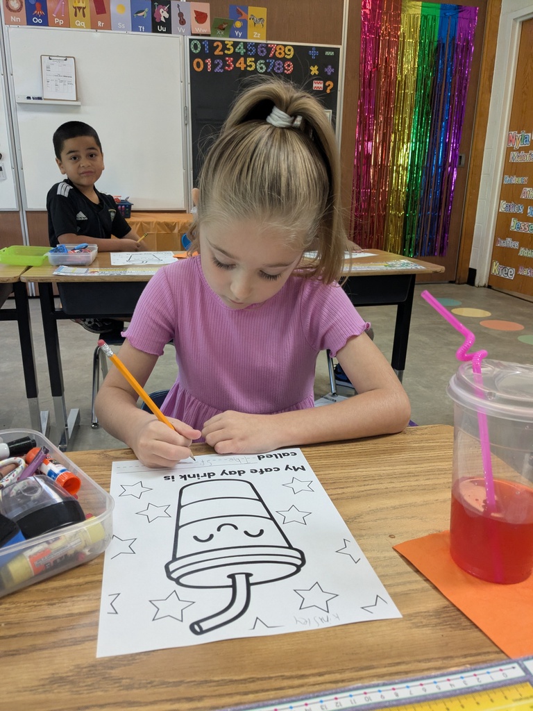 A girl in a purple shirt colors in a drawing of a popsicle on a desk.