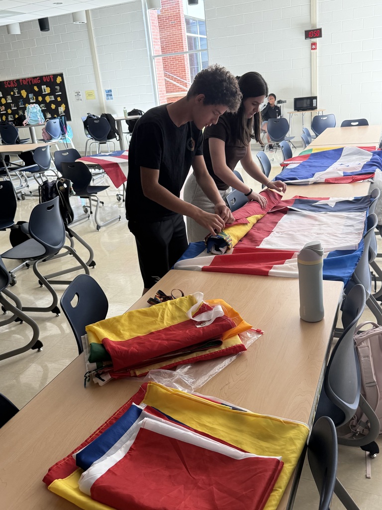 2 students folding flags
