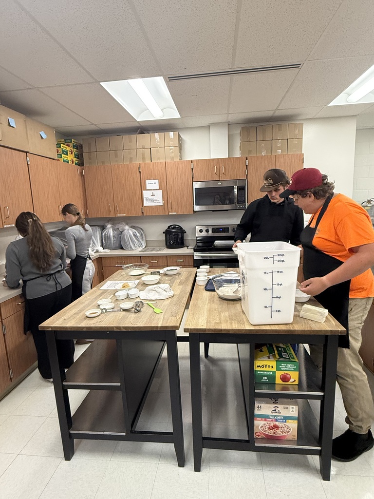 4 students work in a kitchen