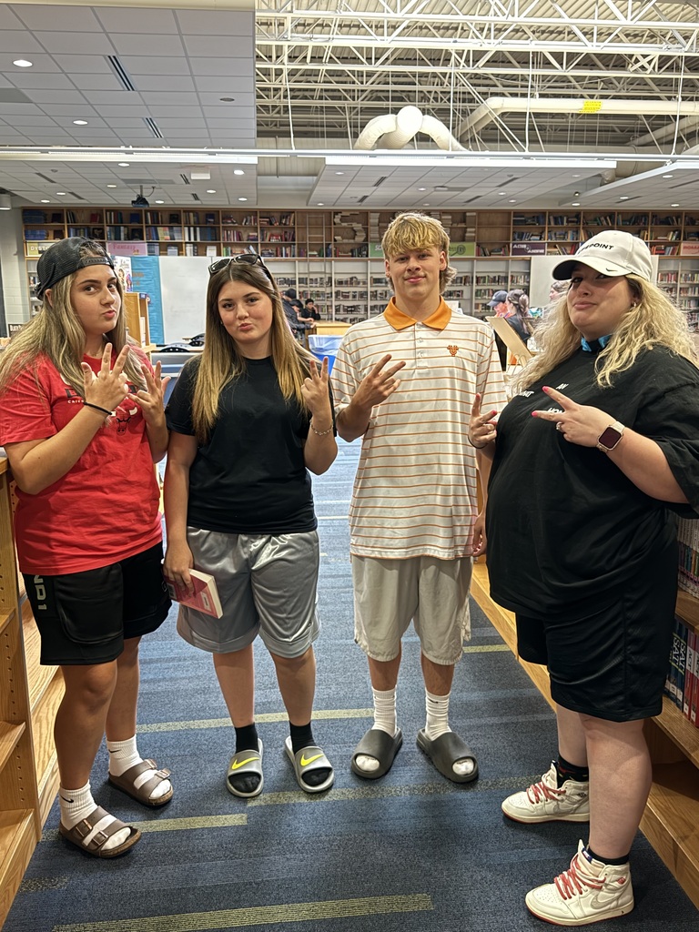 a teacher and 3 students dressed in baggy clothes