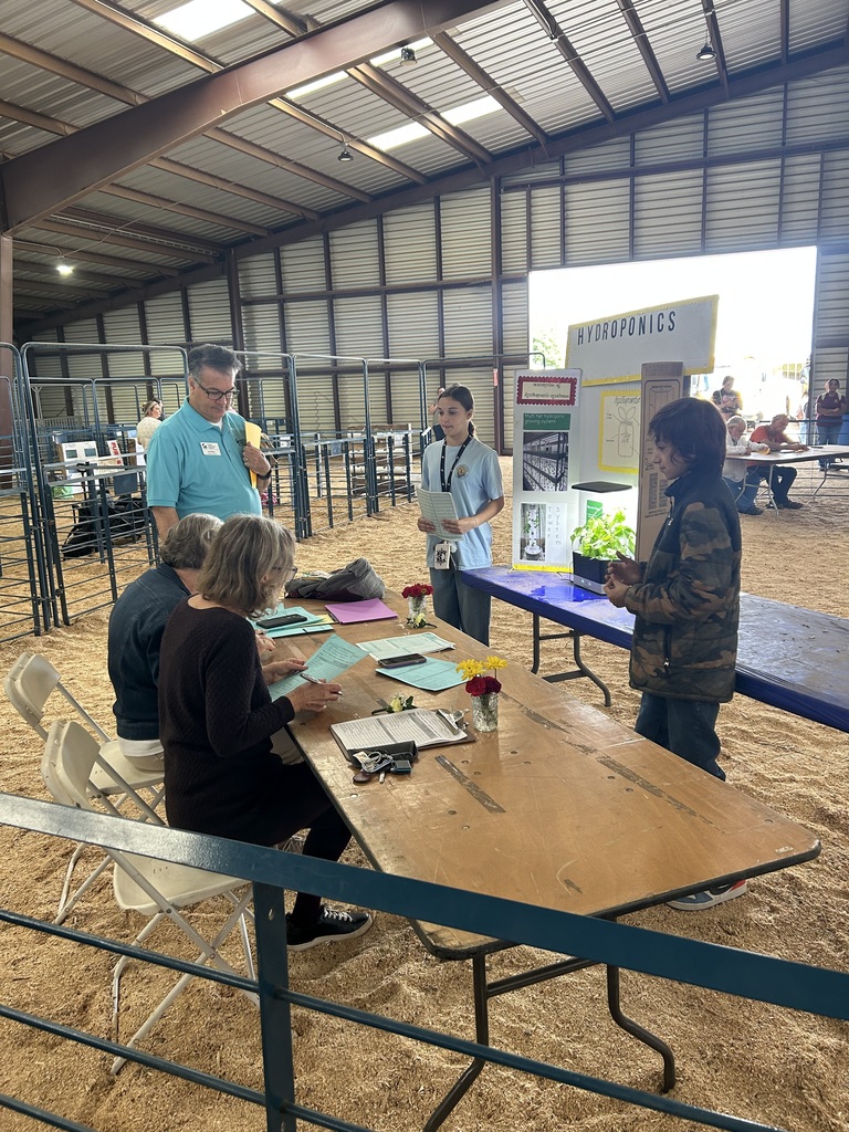 Two CMS FFA students present their hydroponics project to judges during an agricultural competition at the State Fair of Virginia.
