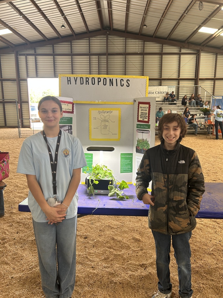 Two CMS FFA students stand beside their hydroponics display and growing system at the State Fair of Virginia.