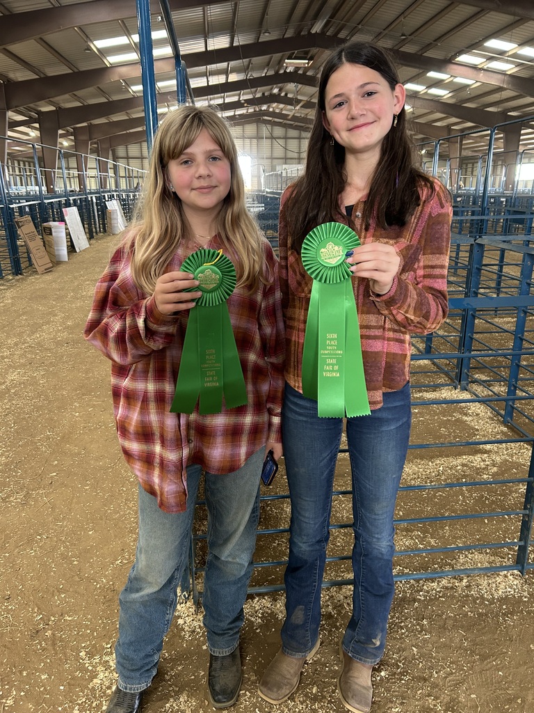 1. Two CMS FFA students hold green sixth-place ribbons earned during competition at the State Fair of Virginia.