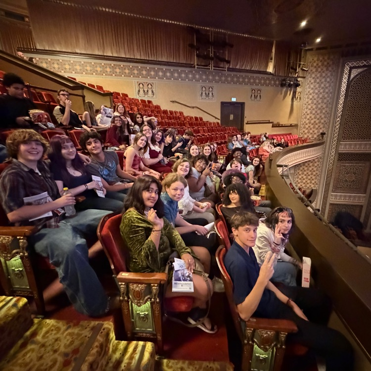 students in seats in an auditorium 