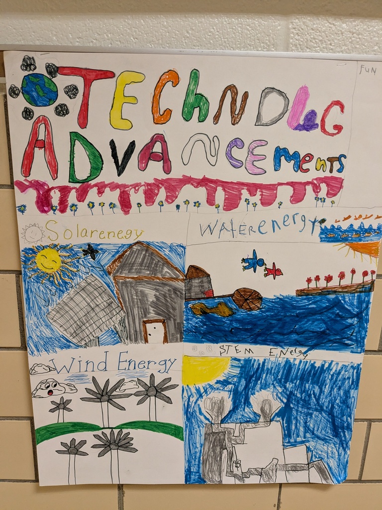 A large white poster on a tiled wall. It has colorful drawings of houses, water, wind turbines, and the sun.