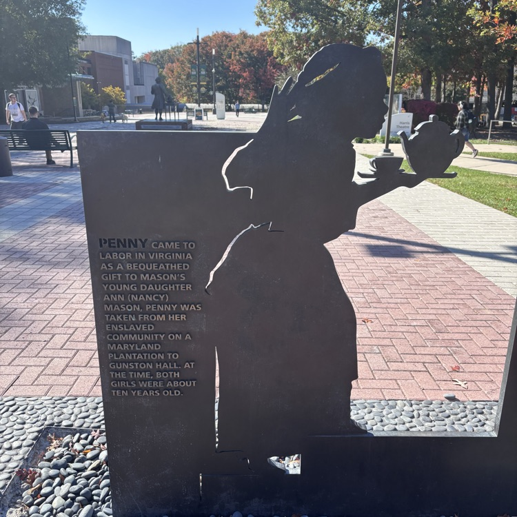 A brick walkway shows a silhouette of a girl holding a bowl, with text on a stone.