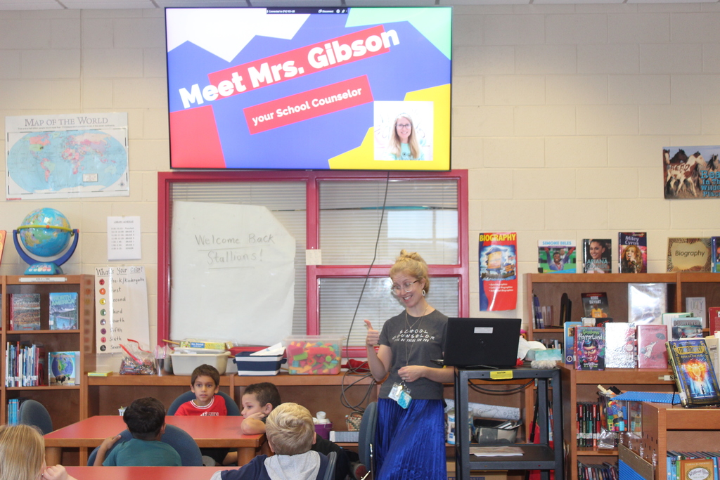 Mrs. Gibson introducers herself to a  library full of first graders.  