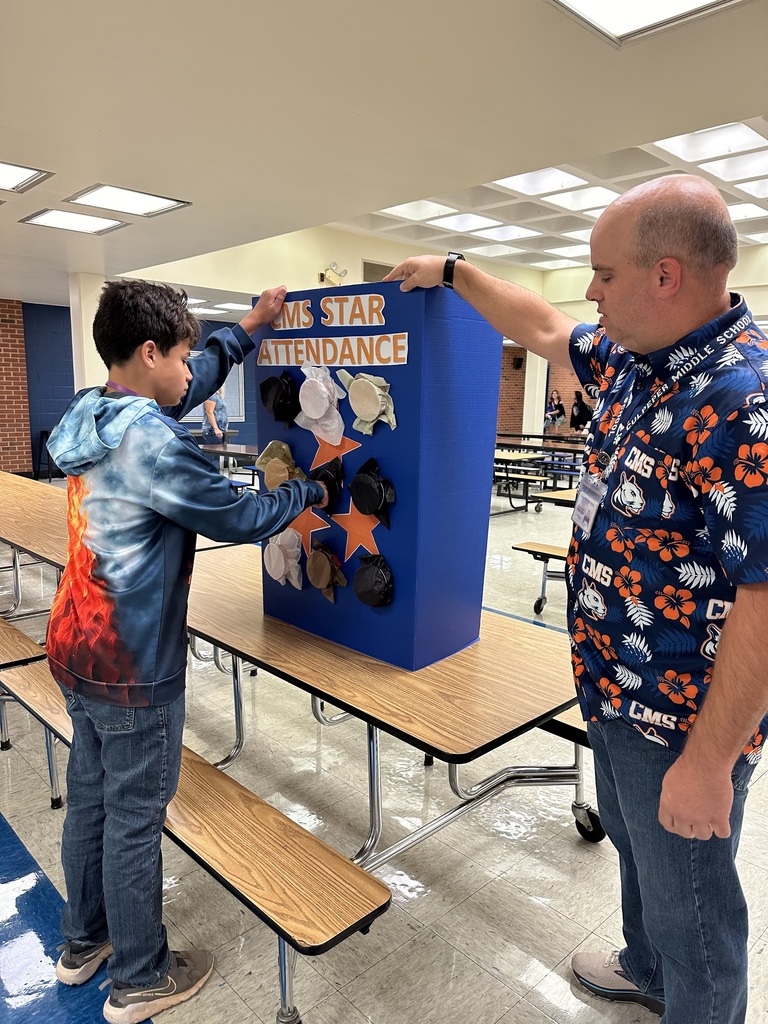 Students picking their award for the CMS star attendance