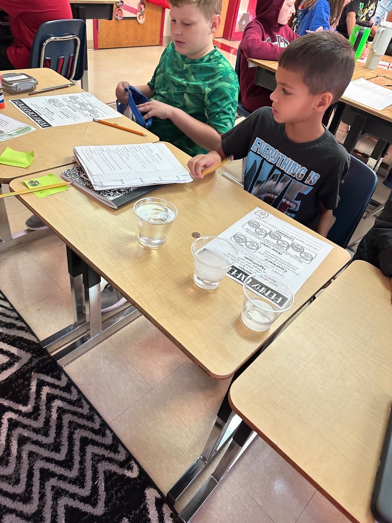 two studentsrecord their data after experimenting with cleaning solutions and dirty pennies to see which solution works best to clean them 