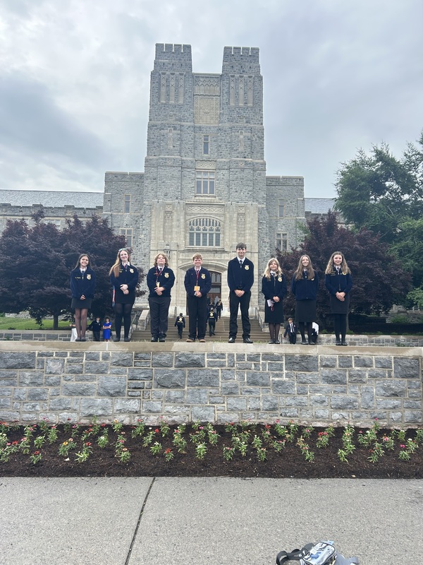 students in FFA jackets standing in front of historic building at Virginia Tech