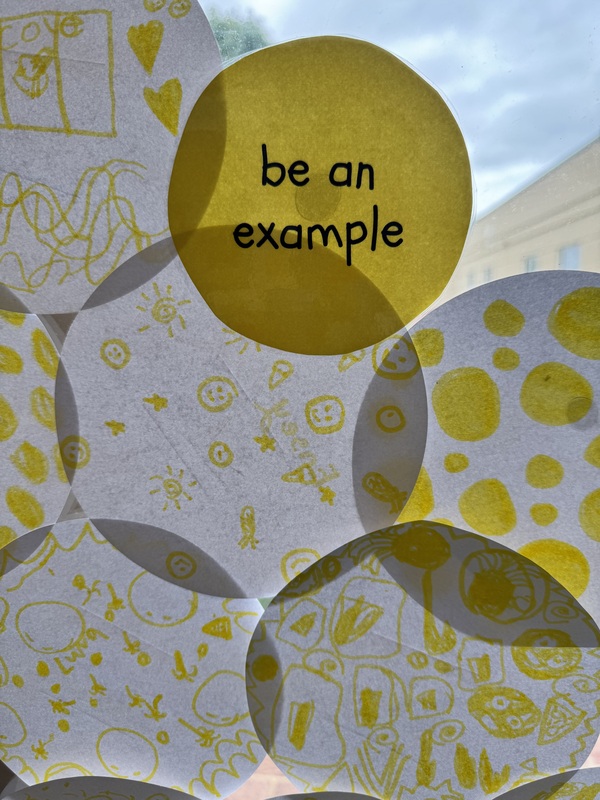 a yellow circle that says be an example