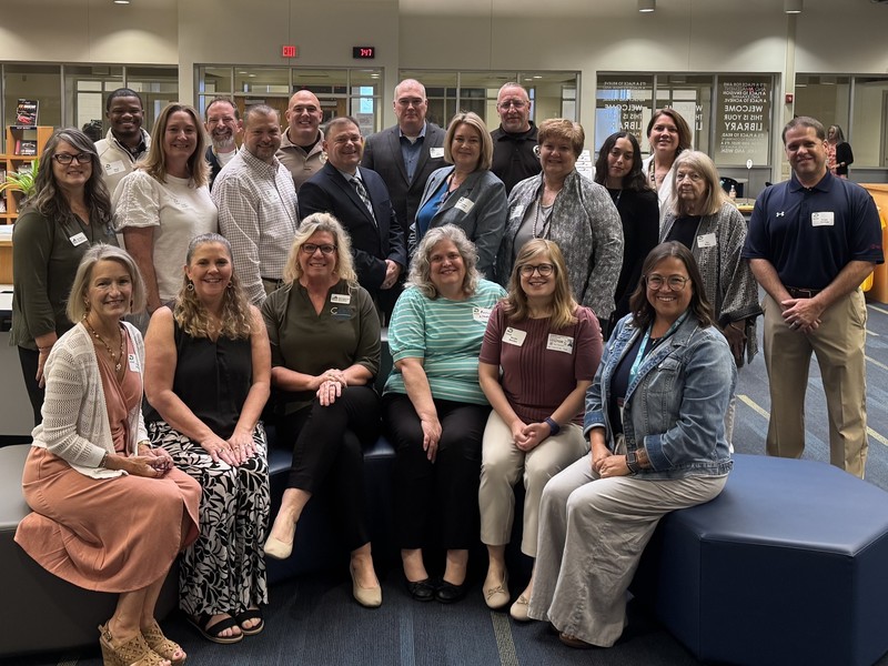 group picture of teachers and community members in CCHS Library for mock interviews