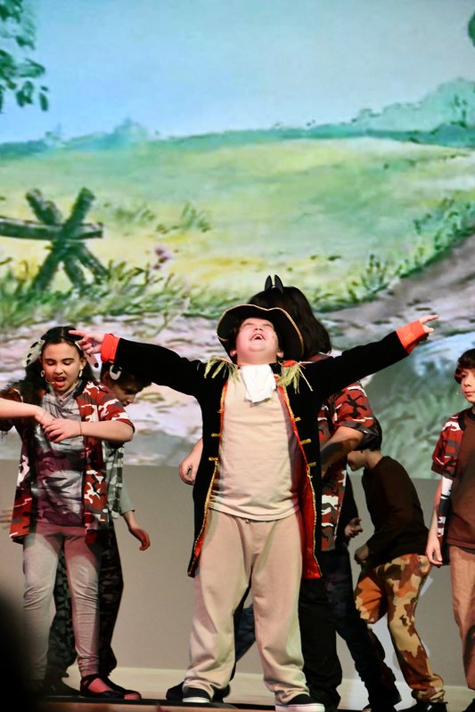 students in theatre production singing