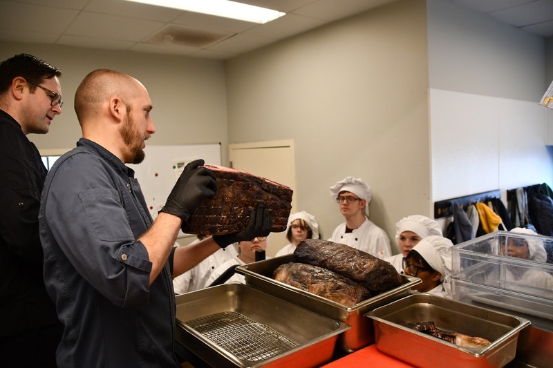 chef shows students large piece of aged wagu beef