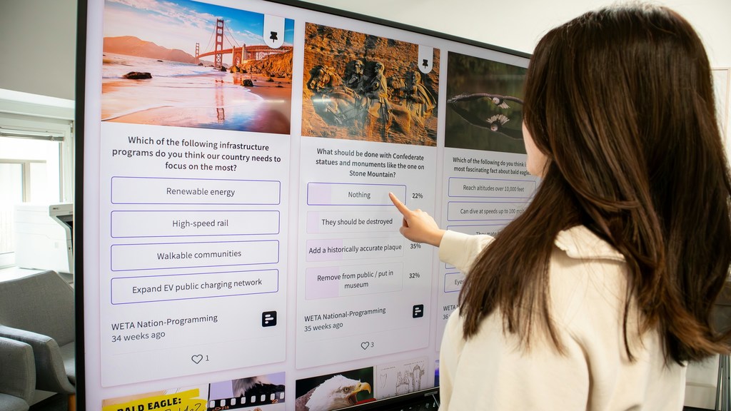 Student interacting with technology board at front of class