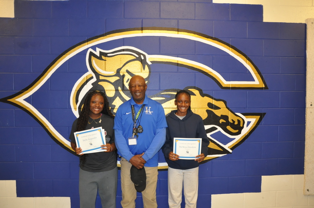 Jayla Augustin, Coach Kenneth Jasey, and Ma’Kiya Hawkins.