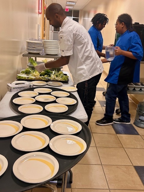Earl Lee preparing plates