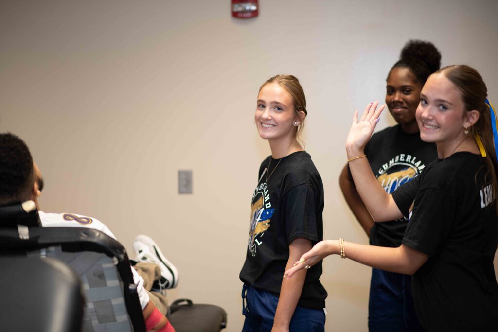 Nursing students lending a hand to volunteers.