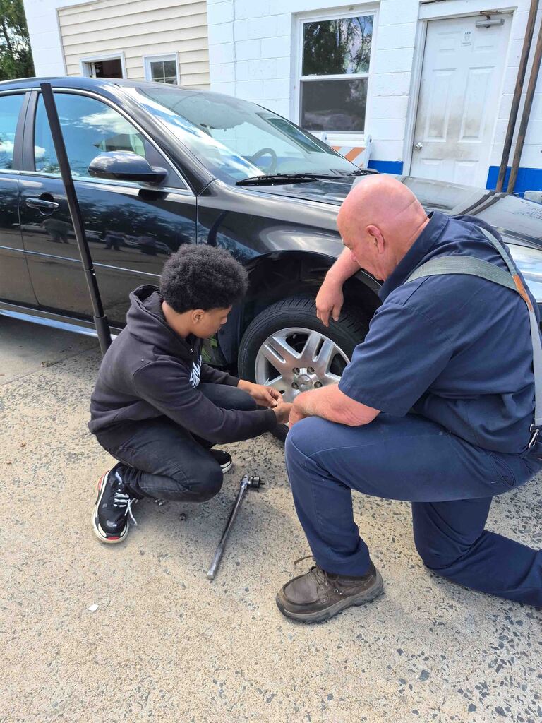 Mrs. Wrenn's students learn to change a tire.
