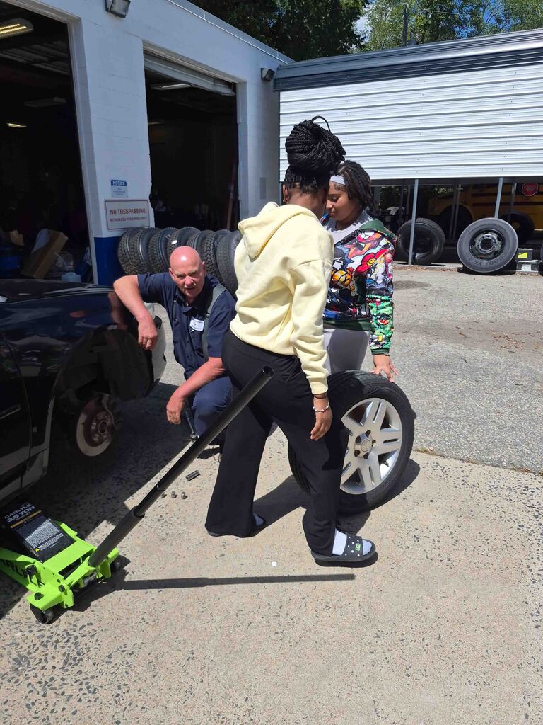 Mrs. Wrenn's students learn to change a tire.