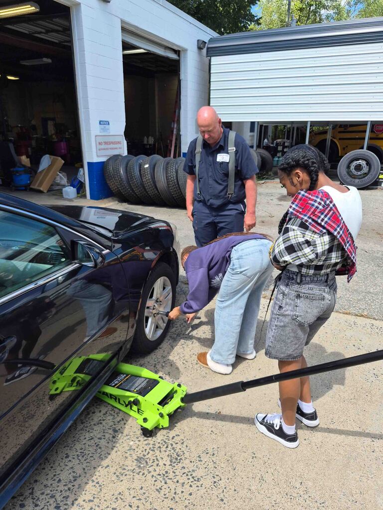 Mrs. Wrenn's students learn to change a tire.