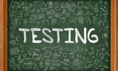 The word "testing" on a chalkboard