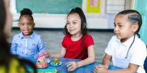 teacher at a table with children