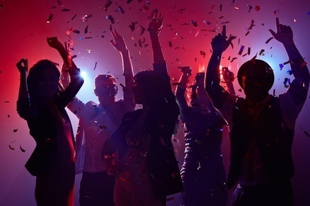 Students dancing with confetti with pink backlight