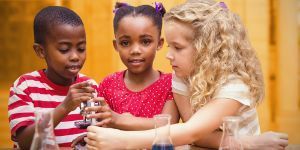 elementary students holding microscope