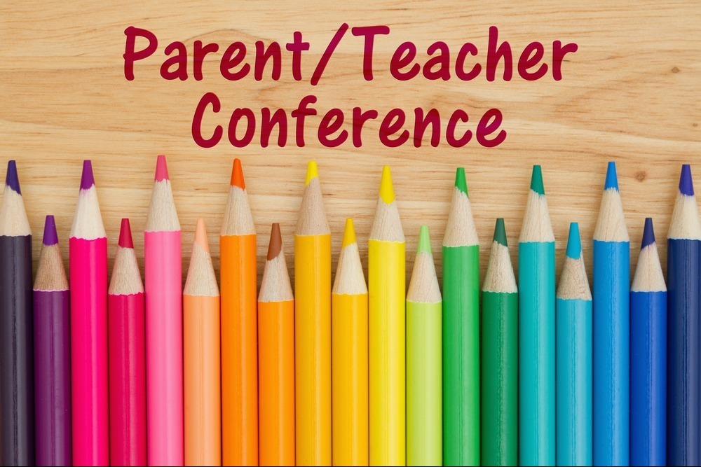 wood background with red letters and different colors of colored pencils