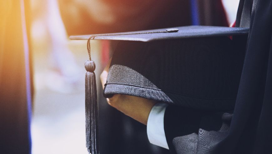 student holding graduation cap