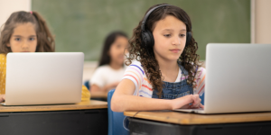 students wearing headphones while working on computers