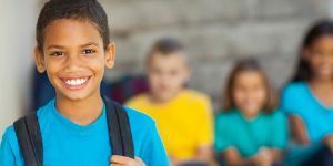 Image of smiling boy with out of focus children in background