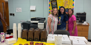 image of women in breakroom with breakfast on table
